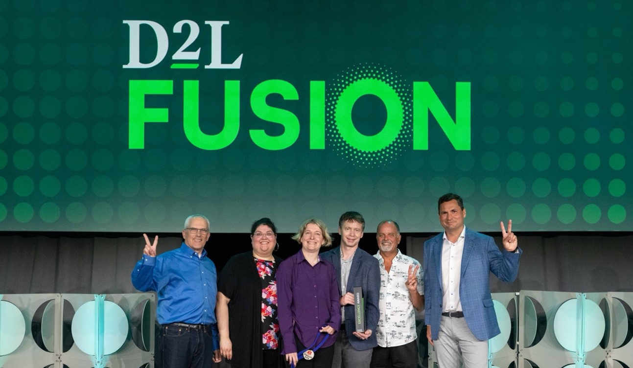 CTE group with D2L members accepting award at D2L Fusion conference.