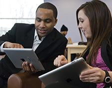 Instructor working with student on tablet