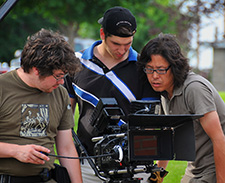 three students video recording outdoor scene