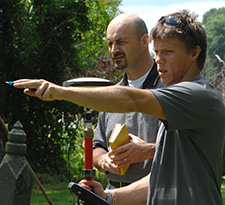 Instructor, outdoors, helping student with field research