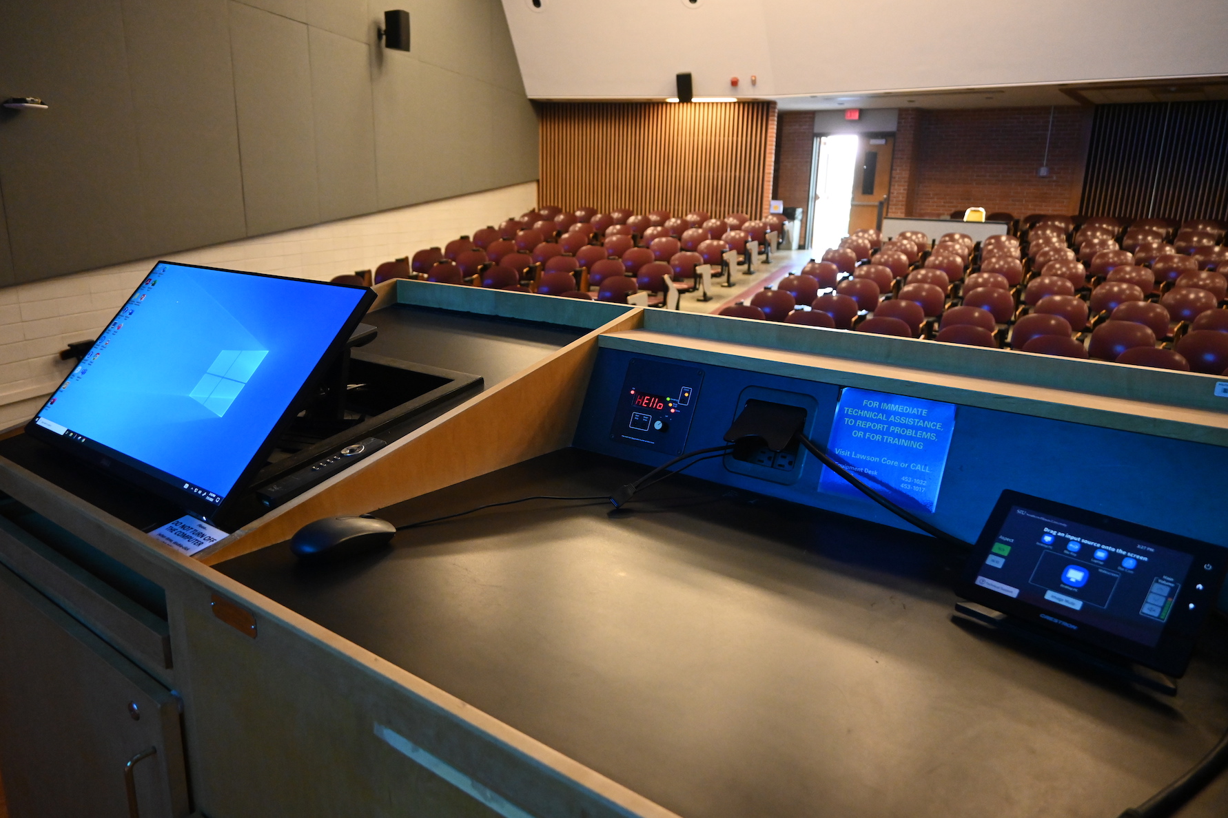 Image showing top of podium with computer and control system in "Large Auditoria" classroom.